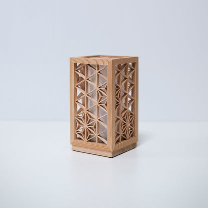A table lamp using kumiko, a traditional Japanese technique of assembling small wooden pieces to create geometric patterns.