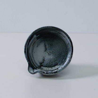 Inside view of a Japanese matcha bowl with spout "Creative Cloud" pottery, showing the white and black gradient glaze, Japan.