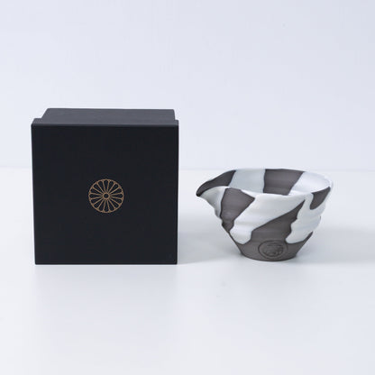 Japanese matcha bowl with spout "White Flow" pottery next to a black gift box with a gold chrysanthemum crest, made in Japan.