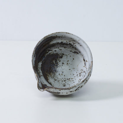 Inside view of a Japanese matcha bowl with spout Zui pottery, showing the uneven white and brown glaze texture, made in Japan.