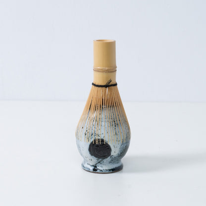 White and black Japanese matcha whisk stand "Creative Cloud" pottery chasen stand with a bamboo tea whisk placed on top, made in Japan.