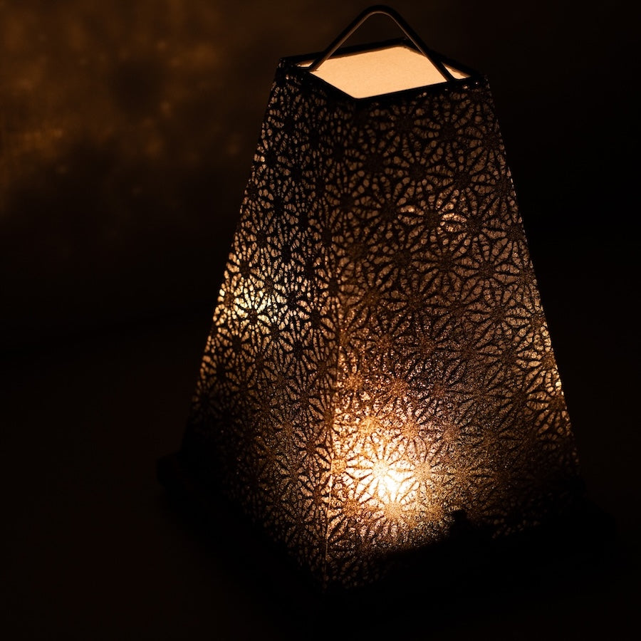 Japanese Paper Table Lamp "Mini Akari", black, Mino Washi paper - angled view of illuminated wabi sabi style paper lamp.