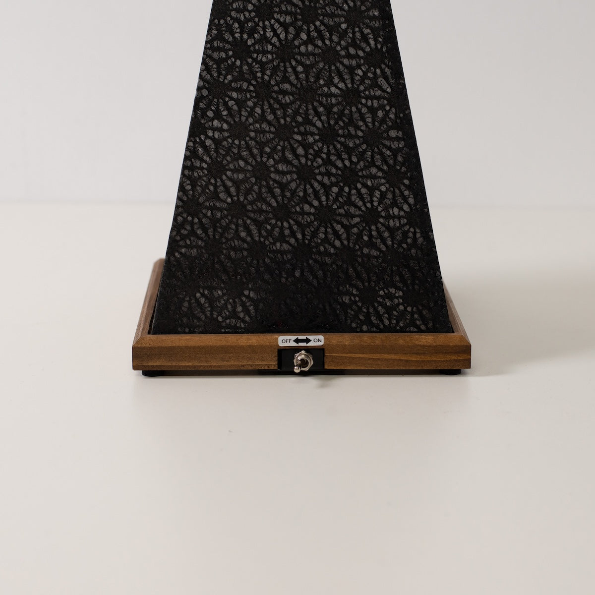 Japanese Paper Table Lamp "Mini Akari", black, wood - close-up of wooden base and toggle switch for the cordless lamp.