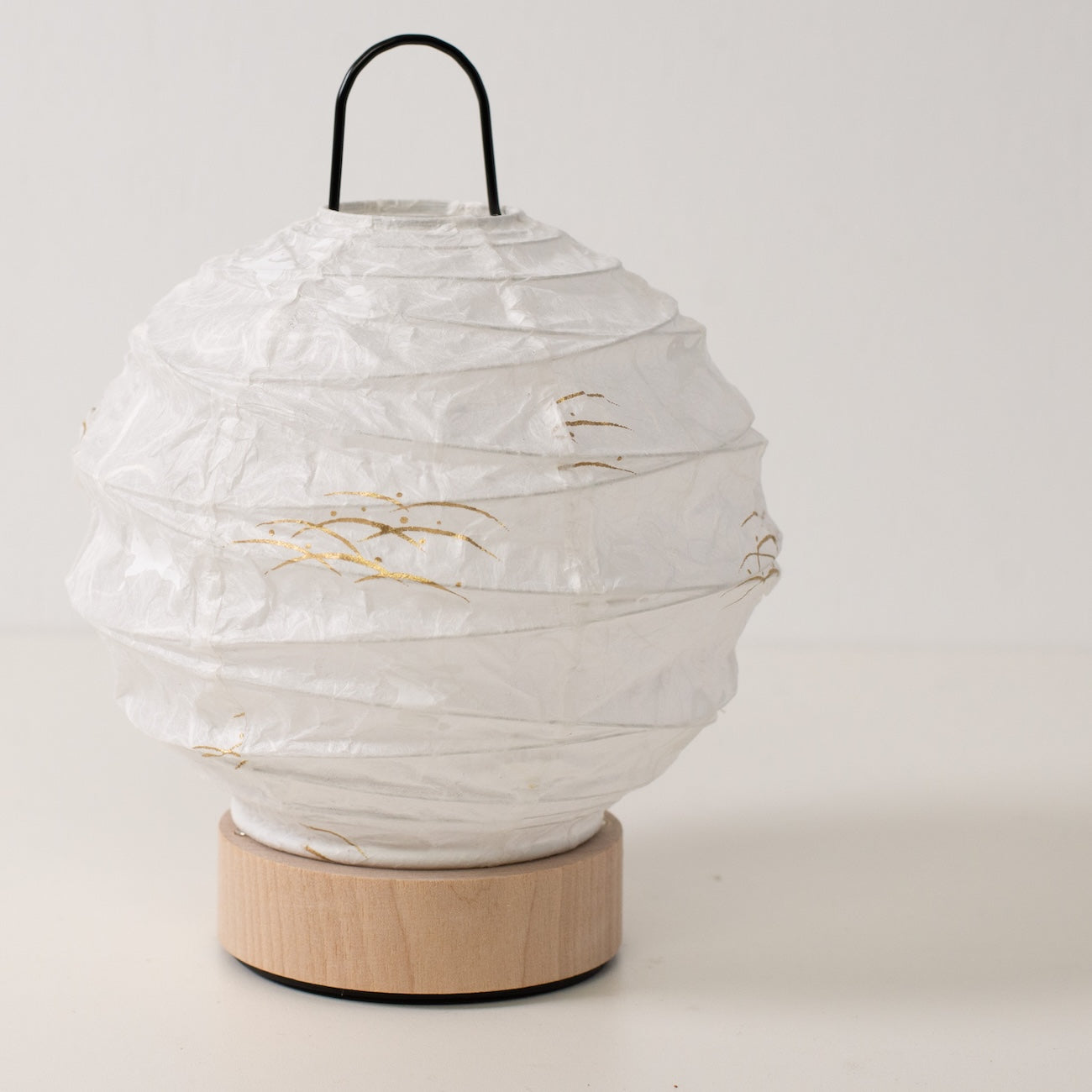 Japanese Paper Table Lamp "Yuhi" Rabbit, white, Mino Washi paper and wood - angled view of unlit round paper lamp and solid base.