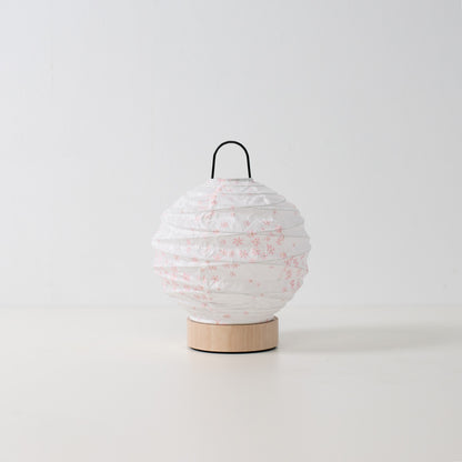 Japanese Paper Table Lamp "Yuhi" Sakura, white, Mino Washi paper and wood - unlit round accent lamp from Japan on a white surface.