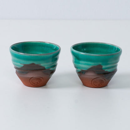 Two Emerald green and orange Japanese sake cups ochoko "Emerald" green pottery from Japan, featuring red clay and an engraved artisan seal.