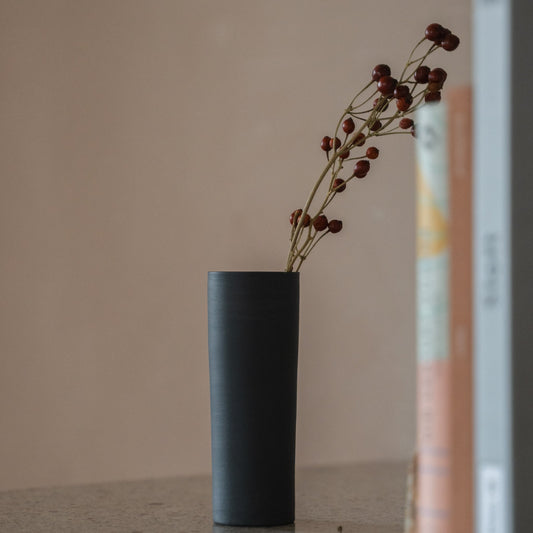 Japanese Single Flower Vase "Cylinder" in black styled in a console table setting, console scene view.