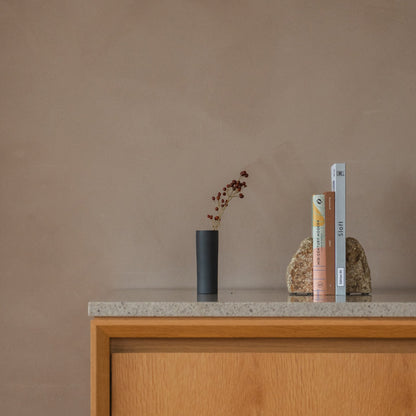 Japanese Single Flower Vase "Cylinder" in black styled in a console table setting, console scene view.