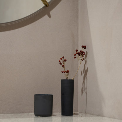 Japanese Single Flower Vase "Cylinder" in black styled in a entryway setting, entryway scene view.