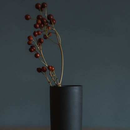 Japanese Single Flower Vase "Cylinder" in black styled in a styled room, detail lifestyle view.