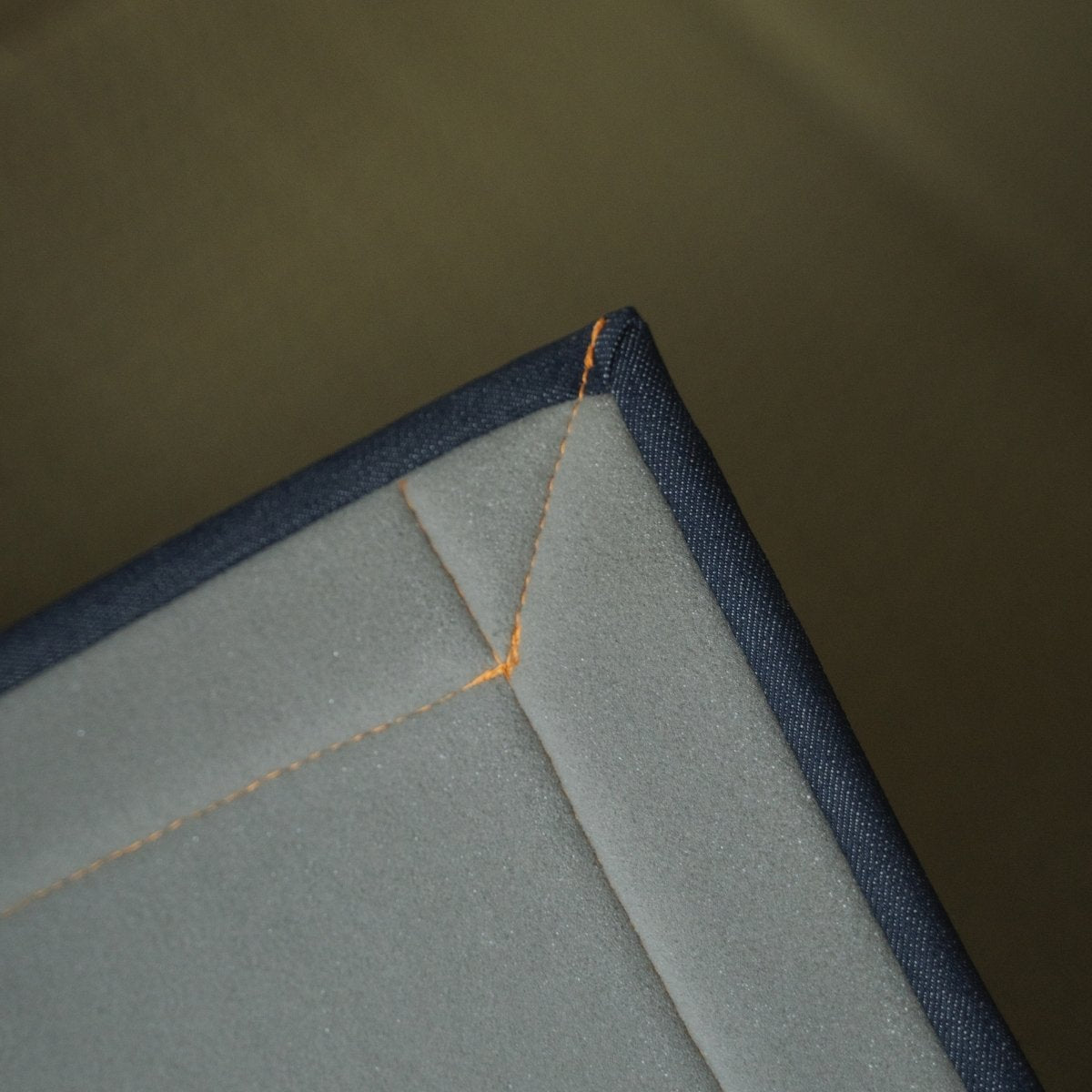 Japanese denim rush tatami area rug showing its urethane foam backing, providing comfortable cushioning for meditation.