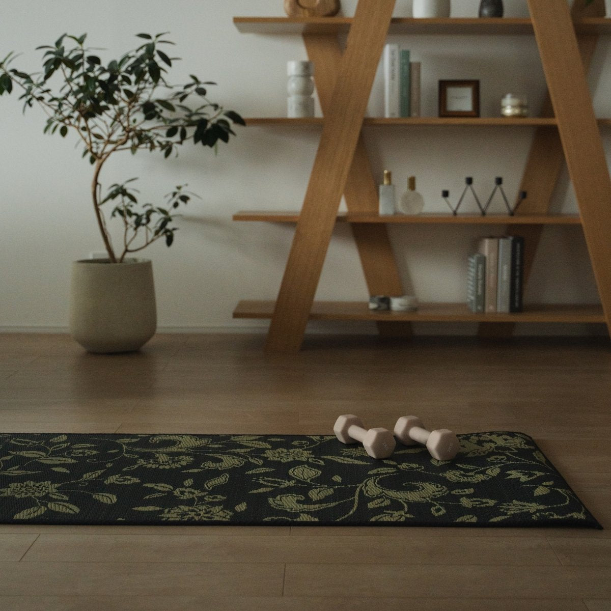 A Japanese Tatami Yoga Mattress "Sarasa" Navy with dumbbells on light wooden floor in a stylish, mindful living space.