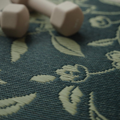 A close-up of the intricate botanical motif on a Japanese Tatami Yoga Mattress "Sarasa" Navy with a dumbbell.