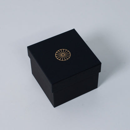 Closed black square Ninshu's box for Japanese incense burner pottery gifts, featuring a gold imperial chrysanthemum crest on the lid.