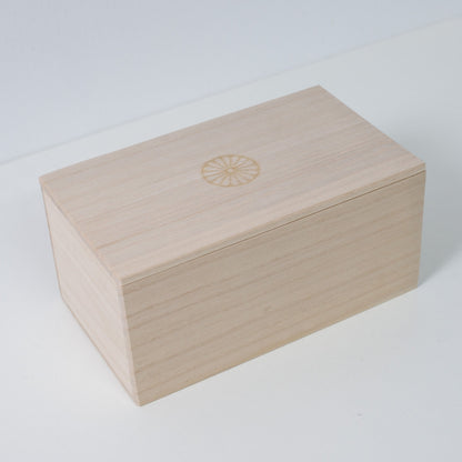 Closed rectangular Ninshu's wooden box for Japanese sake set pottery, featuring a branded chrysanthemum crest on the lid.