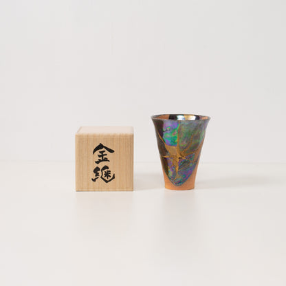 bred iriserende kintsugi-kop hviler ved siden af   en trækasse, klar til at blive givet som en unik japansk gave af wabi sabi-kunst